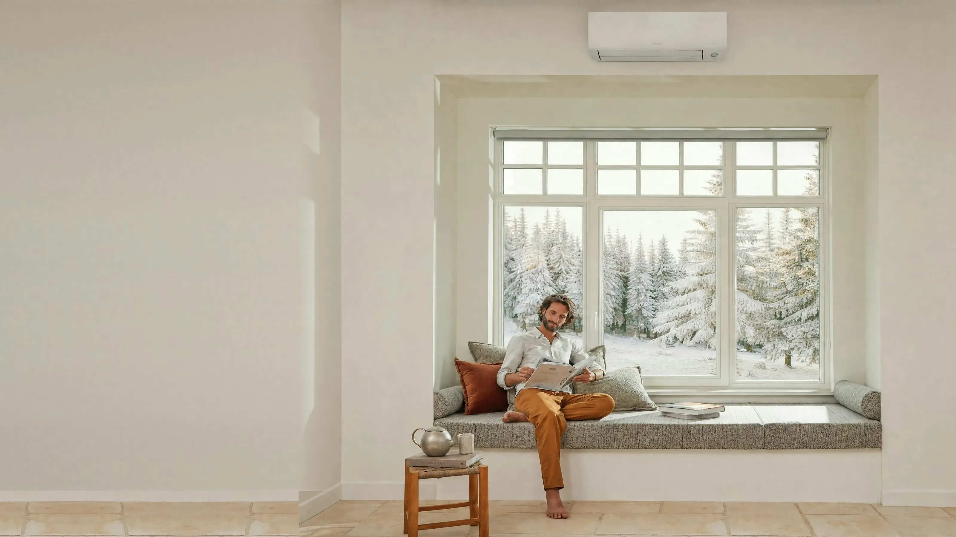 A warm window seat, snow on the pines outside, a wall unit keeping the room at 22 degrees