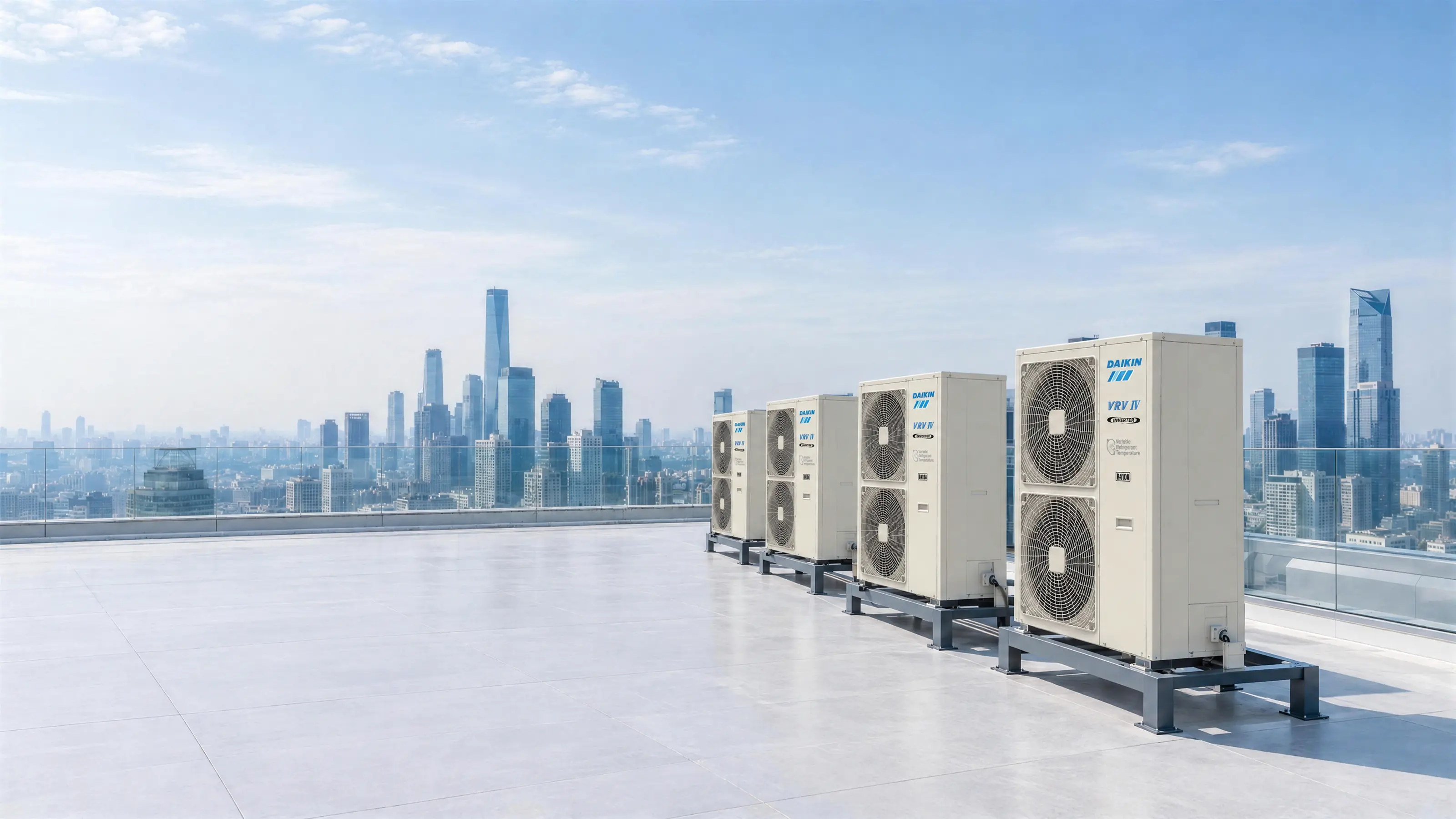 A tower rooftop in clear daylight: a row of Daikin VRV IV outdoor units on their steel frames, the DAIKIN mark on the front of each, the whole skyline behind the glass parapet